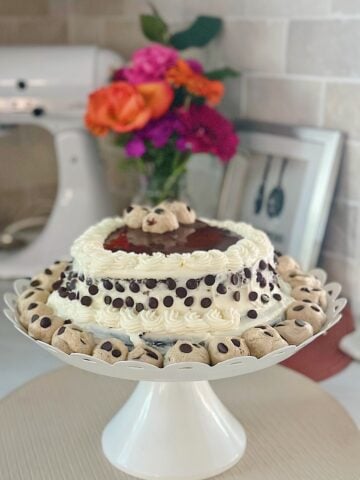 a beautiful chocolate cake with cream cheese frosting and cookie dough crumbles