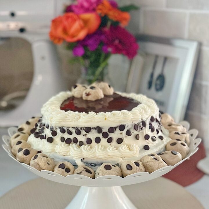 a beautiful chocolate cake with cream cheese frosting and cookie dough crumbles