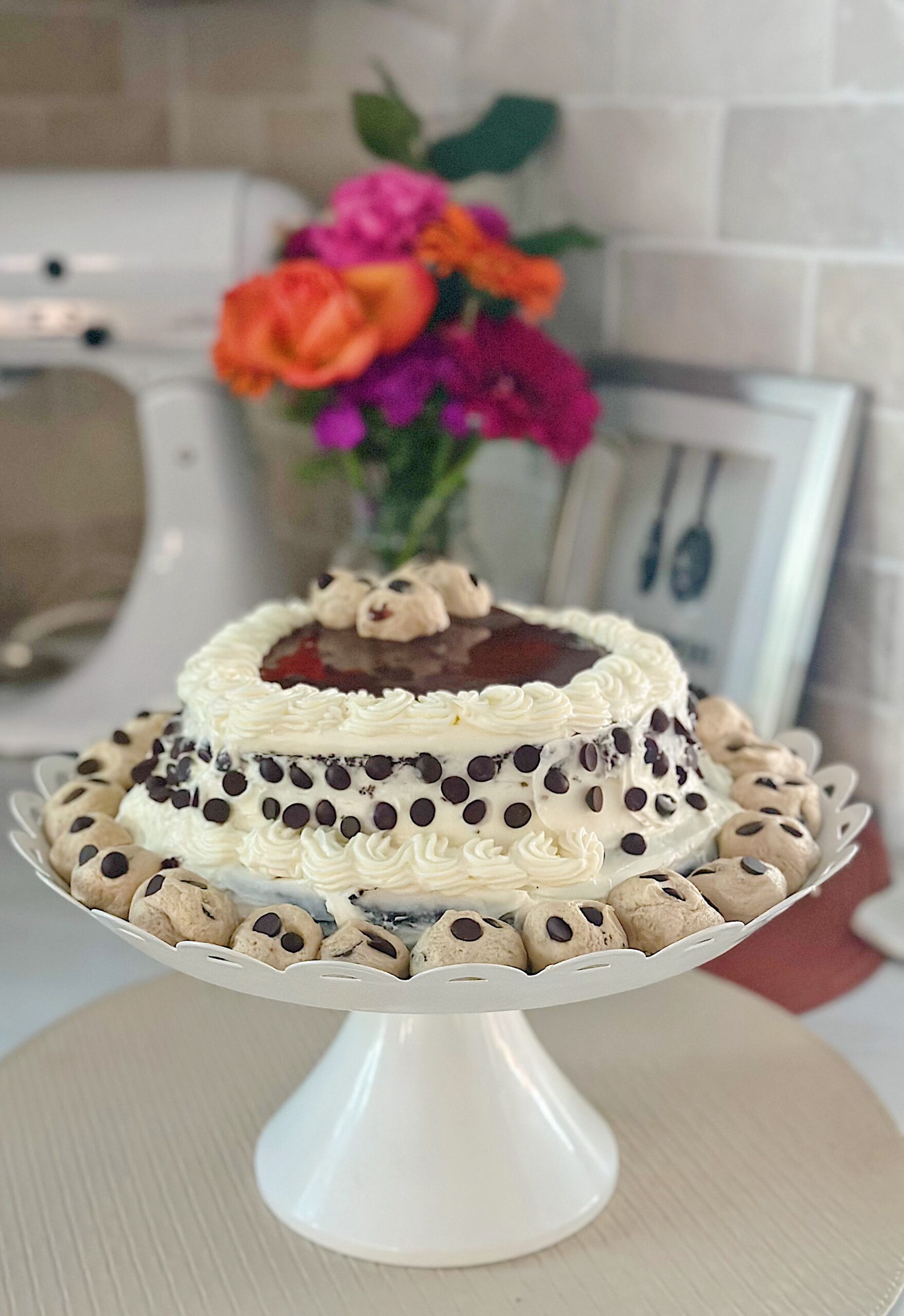 a beautiful chocolate cake with cream cheese frosting and cookie dough crumbles